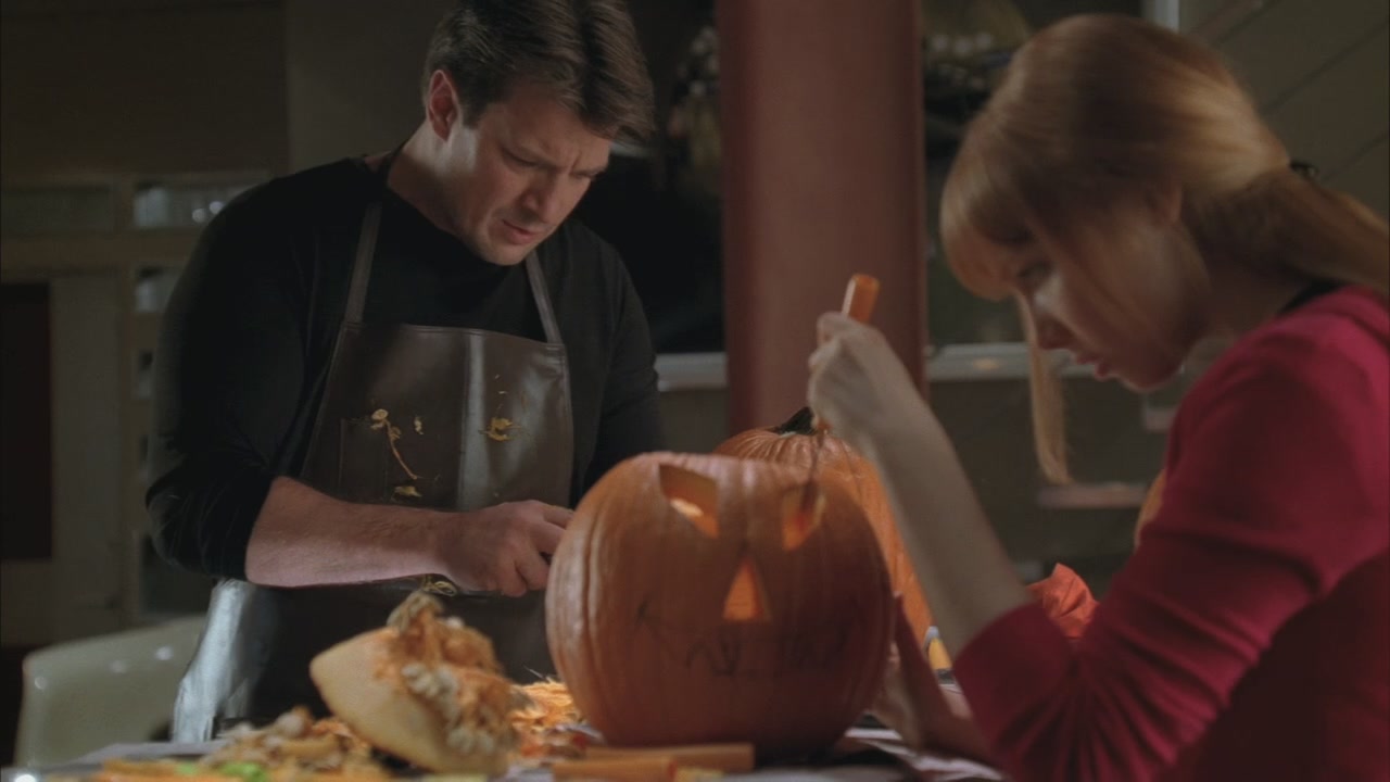 Castle and Alexis carve pumpkins.